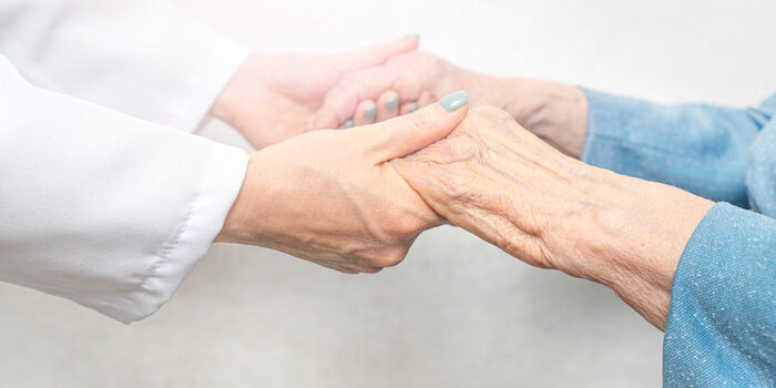 Helping and care for the elderly concept.Young nurse hands holding an old hands of senior woman.